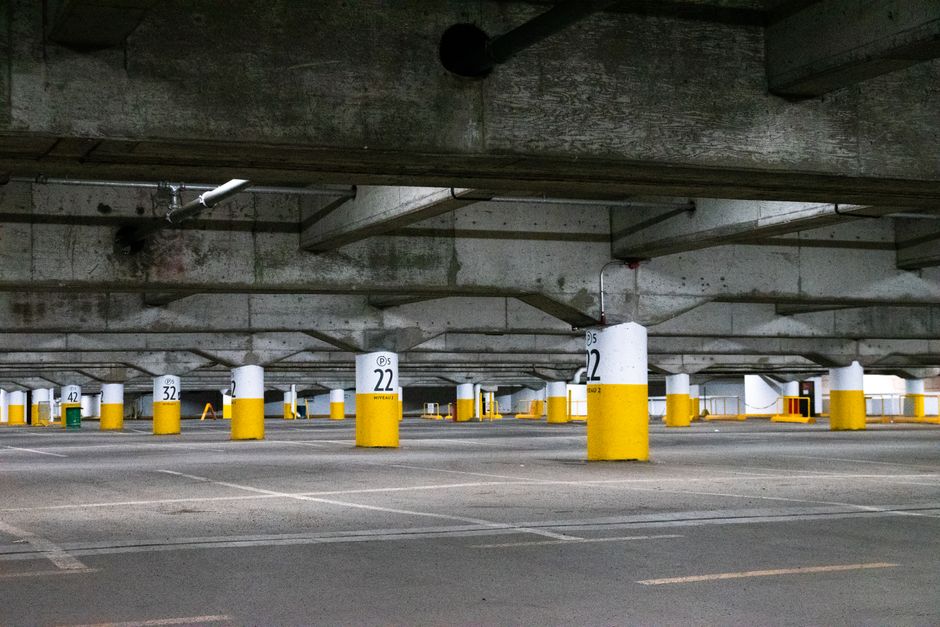 Empty underground parking lot with concrete pillars in Montreal, Canada.